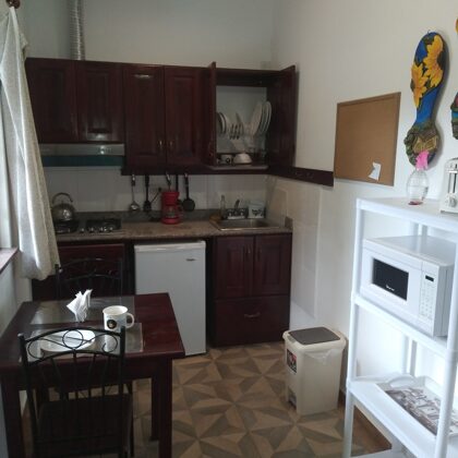 Kitchen with microwave and toaster, fridge, gas range, coffeemaker, ricecooker